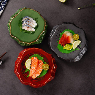 Three colored glaze sashimi plates—green, black, and red—each plated with fish, lime, and shiso on a dark table