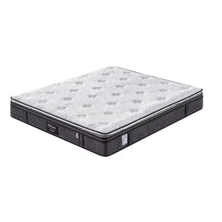 Hotel mattress shown at an angle, white quilted pillow top with black side panels