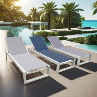 Three commercial sun loungers with white aluminum frames and grey or blue slings beside a pool with palm trees and ocean view