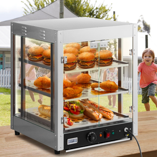 Countertop heated display case with burgers, fried chicken, and hot dogs on three lit shelves, set outdoors near children