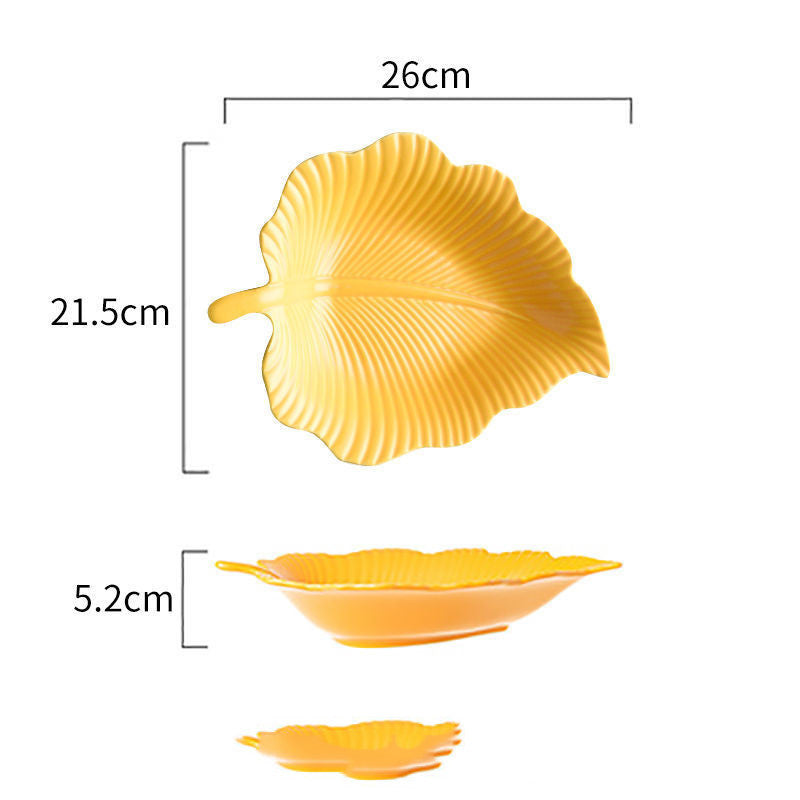 Yellow leaf-shaped ceramic plate with ribbed pattern, top, side, and stacked views with size labels