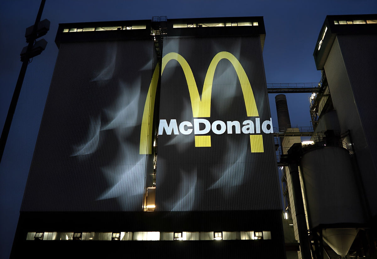 Logo projected across the facade of a building at night
