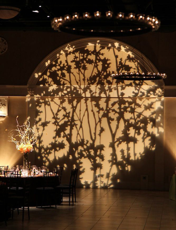 Pattern projected across an interior wall of a venue
