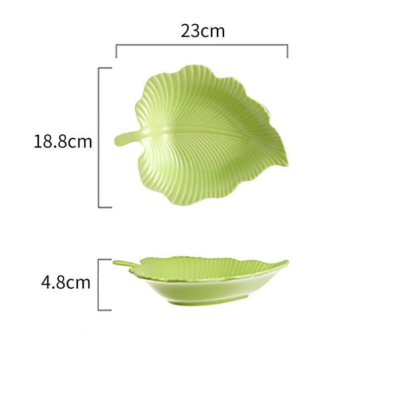 Green leaf-shaped ceramic plate with ribbed texture, top and side views measuring 23cm by 18.8cm