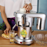 Commercial juicer in use, pouring fresh juice into a glass beside sliced apples