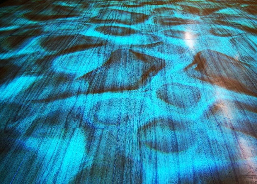 Moving water effect projected across a surface