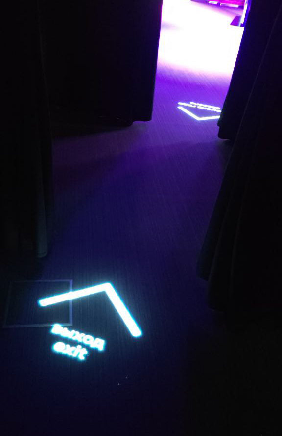 Directional sign projected onto the floor as wayfinding