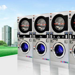Row of stainless steel commercial laundry equipment with stacked washer-dryer combos and blue-lit doors