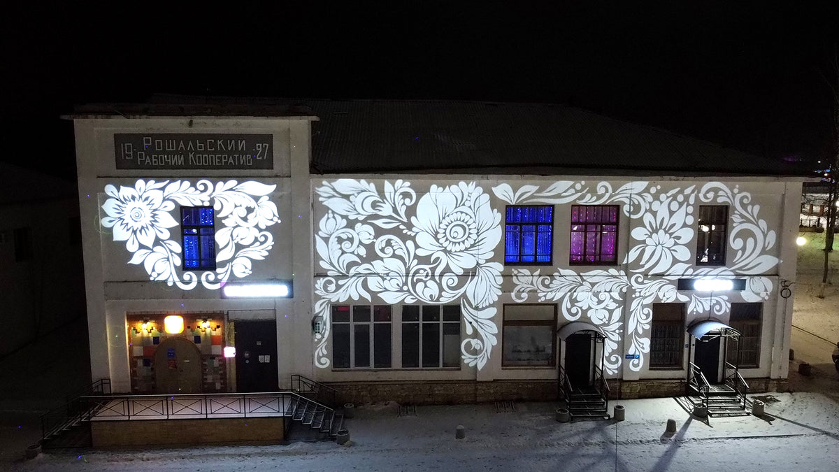 Logo projected across the facade of a building at night
