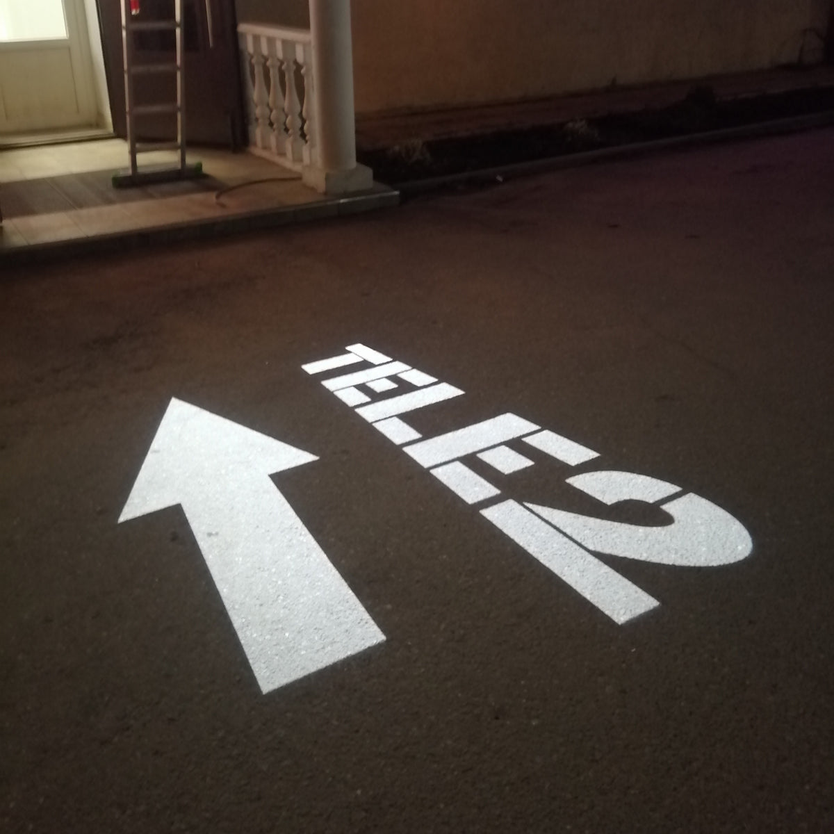 Brand logo projected onto a surface by a gobo projector