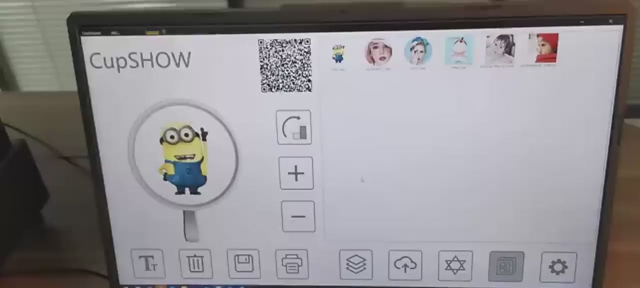 The printing software on a laptop showing the image library and a QR code for guests to upload their own photo