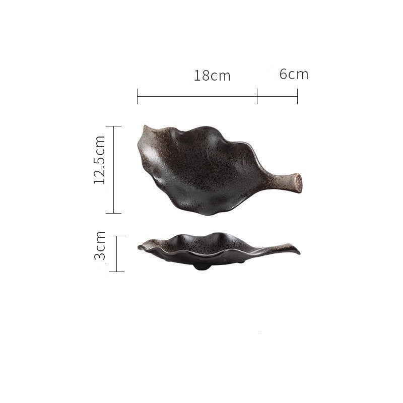 Black leaf-shaped ceramic plate shown from top and side view with measurements 18cm by 12.5cm