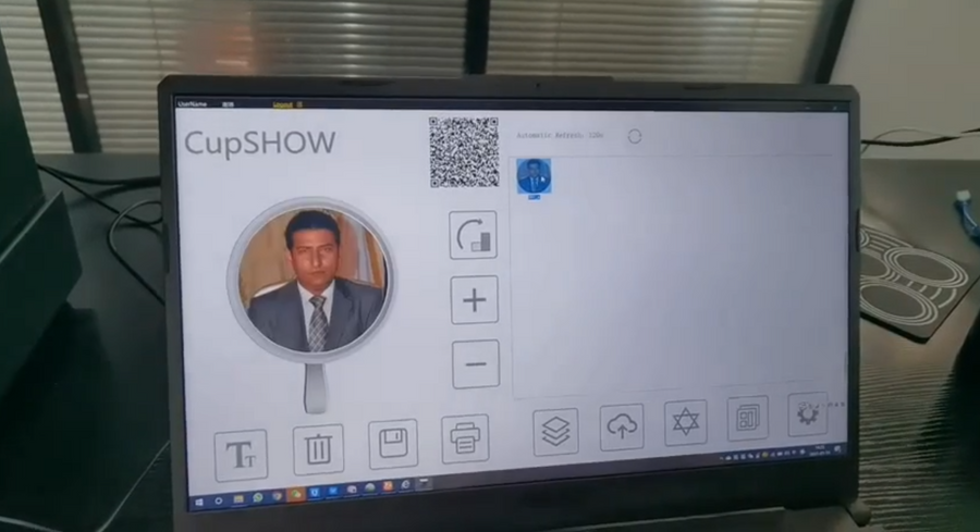 The printing software on a laptop with the image preview, crop handles and resize controls