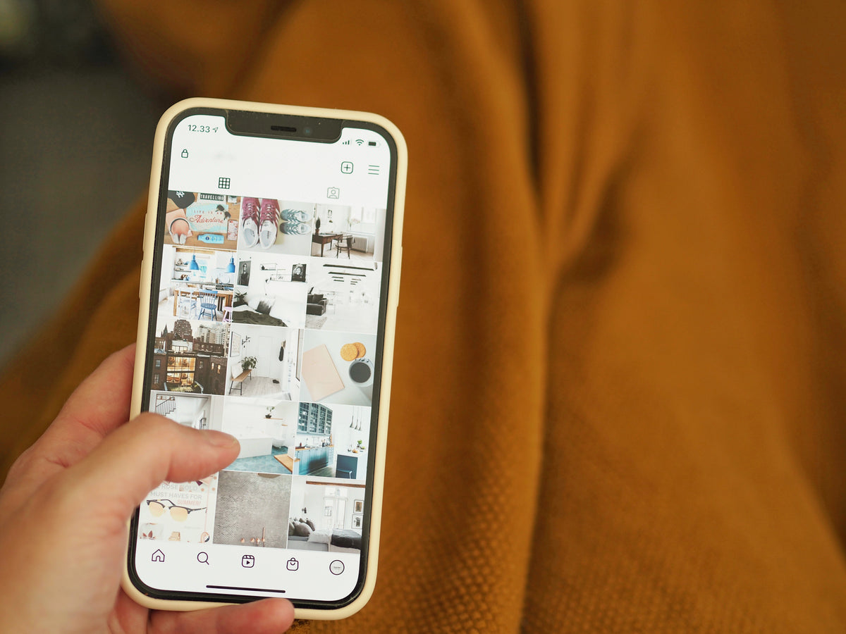Close-up of a guest holding a phone, picking a photo to send to the printer