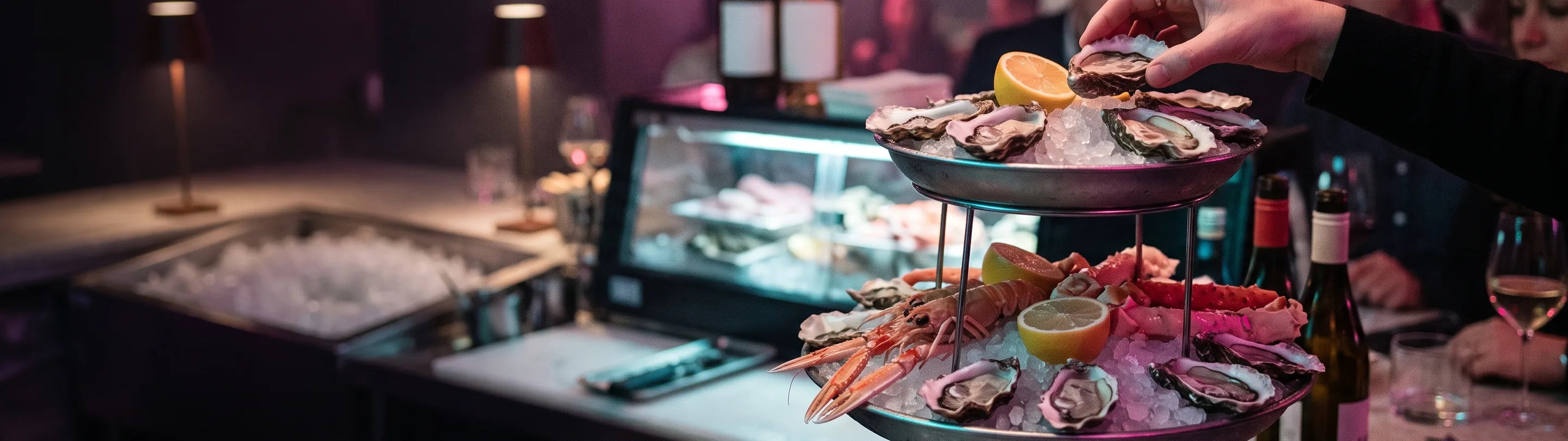 Oysters and shellfish on a crushed-ice display counter, shucking knife beside the tray